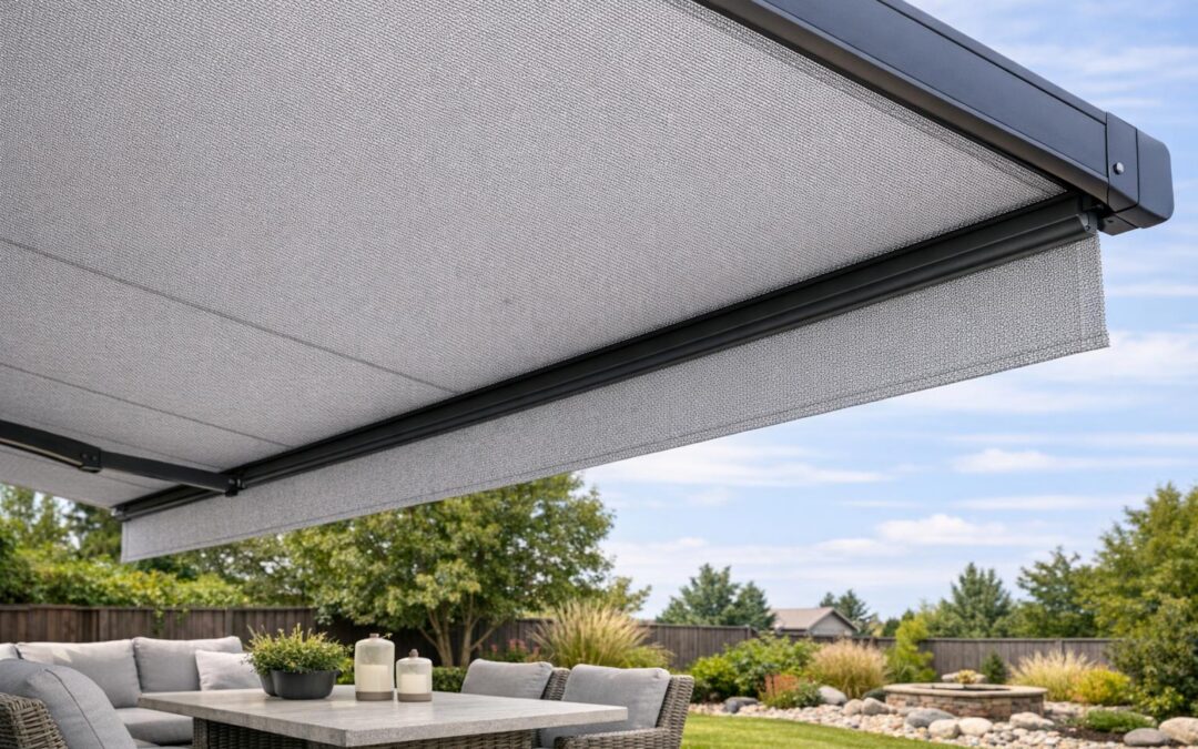 A close-up stock photo of a modern, well-maintained patio awning with new durable fabric extended over a backyard seating area in Boise, Idaho, with no people visible.